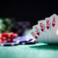 Playing poker in a casino holding winning royal flush hand of cards concept for gambling, betting and winning